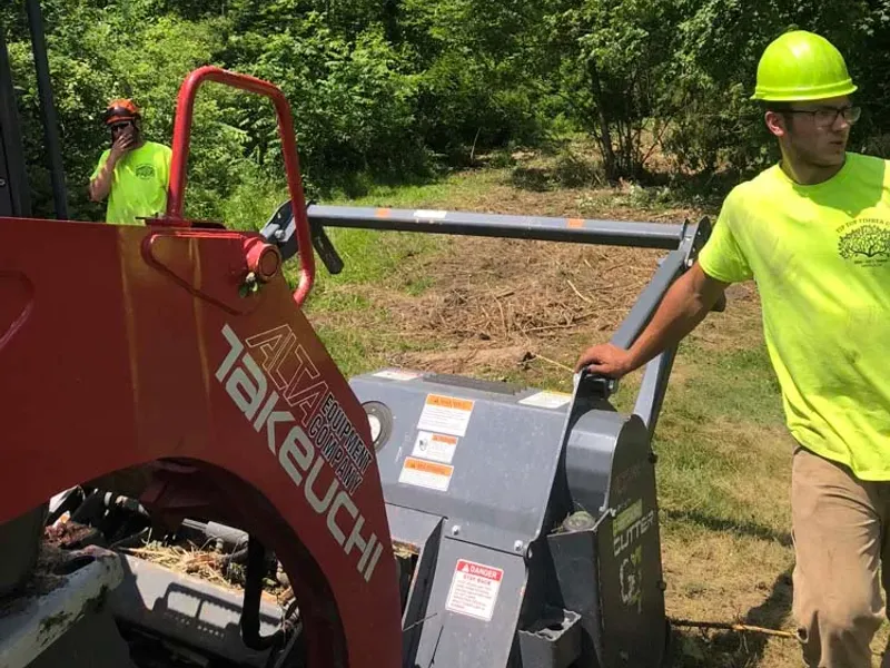 Crew member running a forestry mulcher for brush hogging