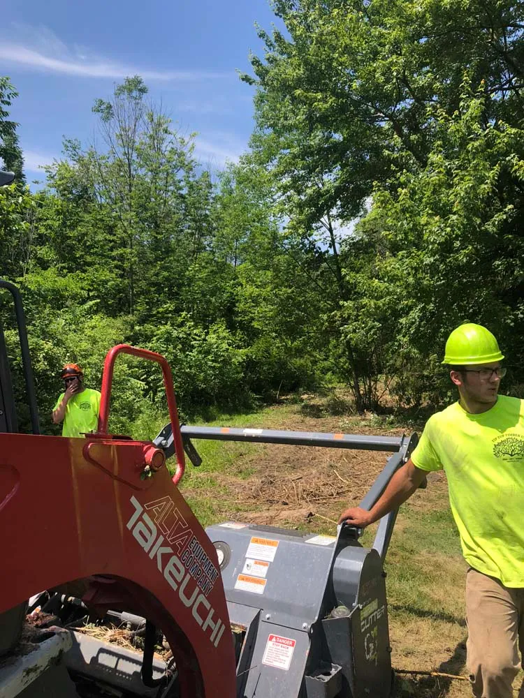 Crew member running a forestry mulcher for brush hogging