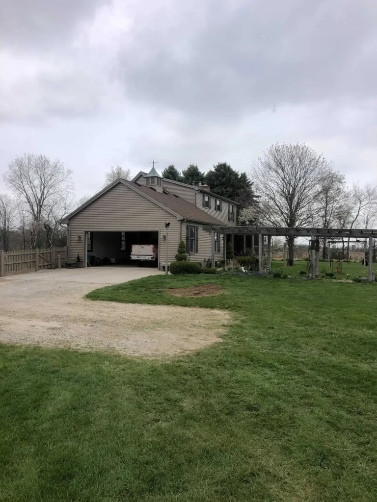 Front yard lawn and driveway after tree removal